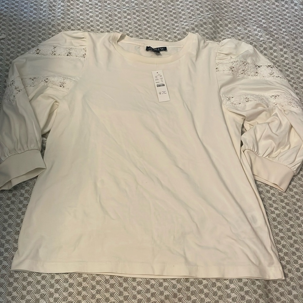 J Crew ivory tee size small. NWT. Beautiful sleeve details.